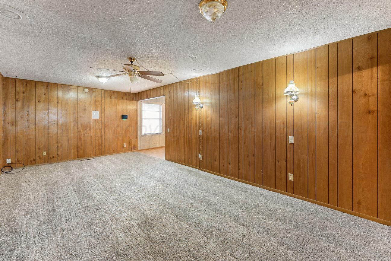 1133 Elmore Street Borger, TX 79007 - Photo 16 of 43 a view of a livingroom with wooden walls