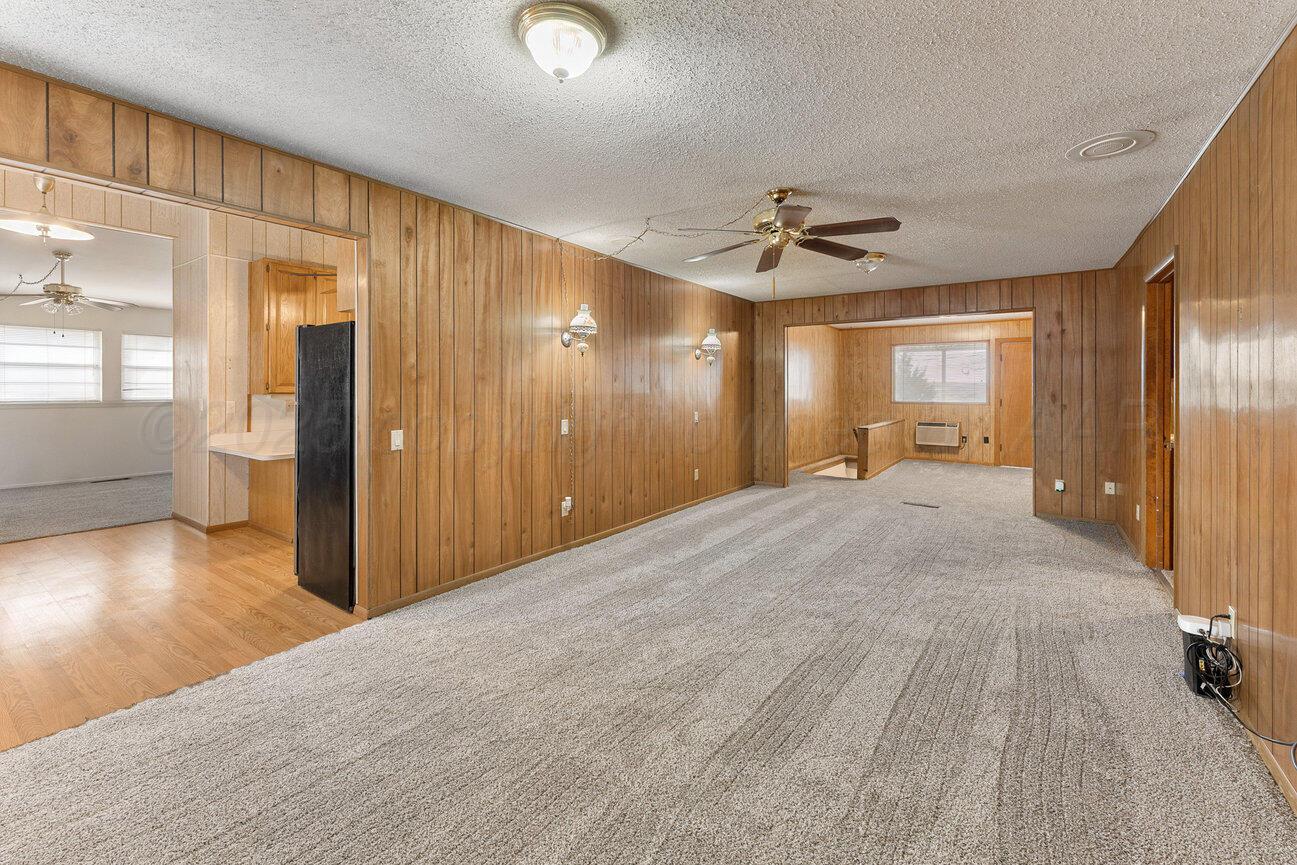 1133 Elmore Street Borger, TX 79007 - Photo 17 of 43 a view of a hallway with wooden floor and a living room