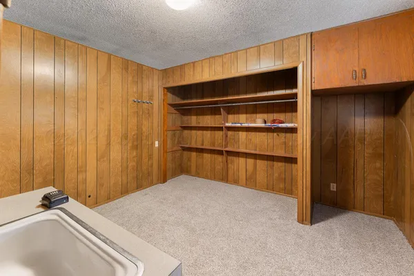 a bedroom with a bed and a cabinet