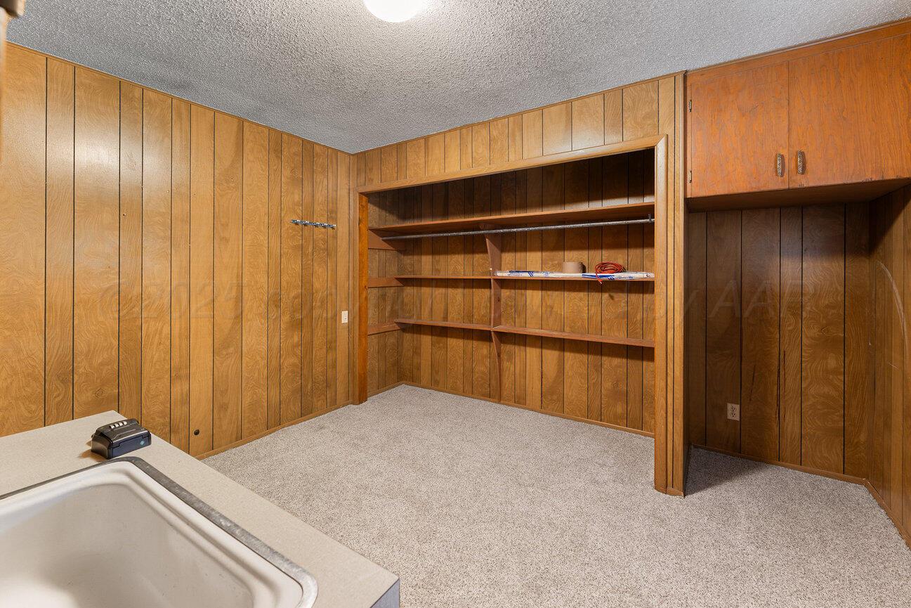 1133 Elmore Street Borger, TX 79007 - Photo 18 of 43 a bedroom with a bed and a cabinet