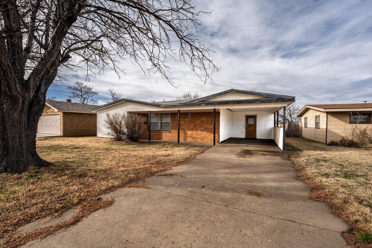 1133 Elmore Street Borger, TX 79007 - Photo 2 of 43 a front view of a house with a yard and garage