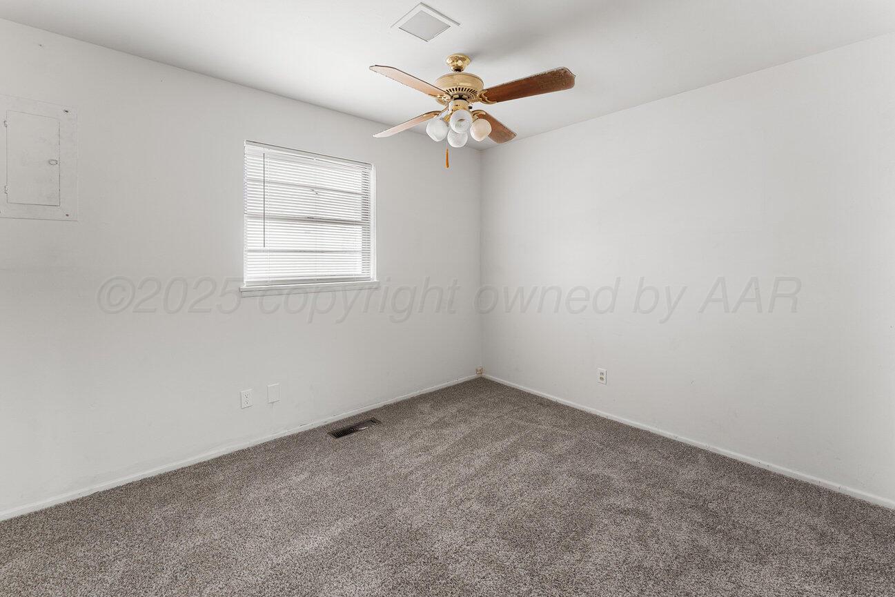 1133 Elmore Street Borger, TX 79007 - Photo 27 of 43 an empty room with a window and a fan