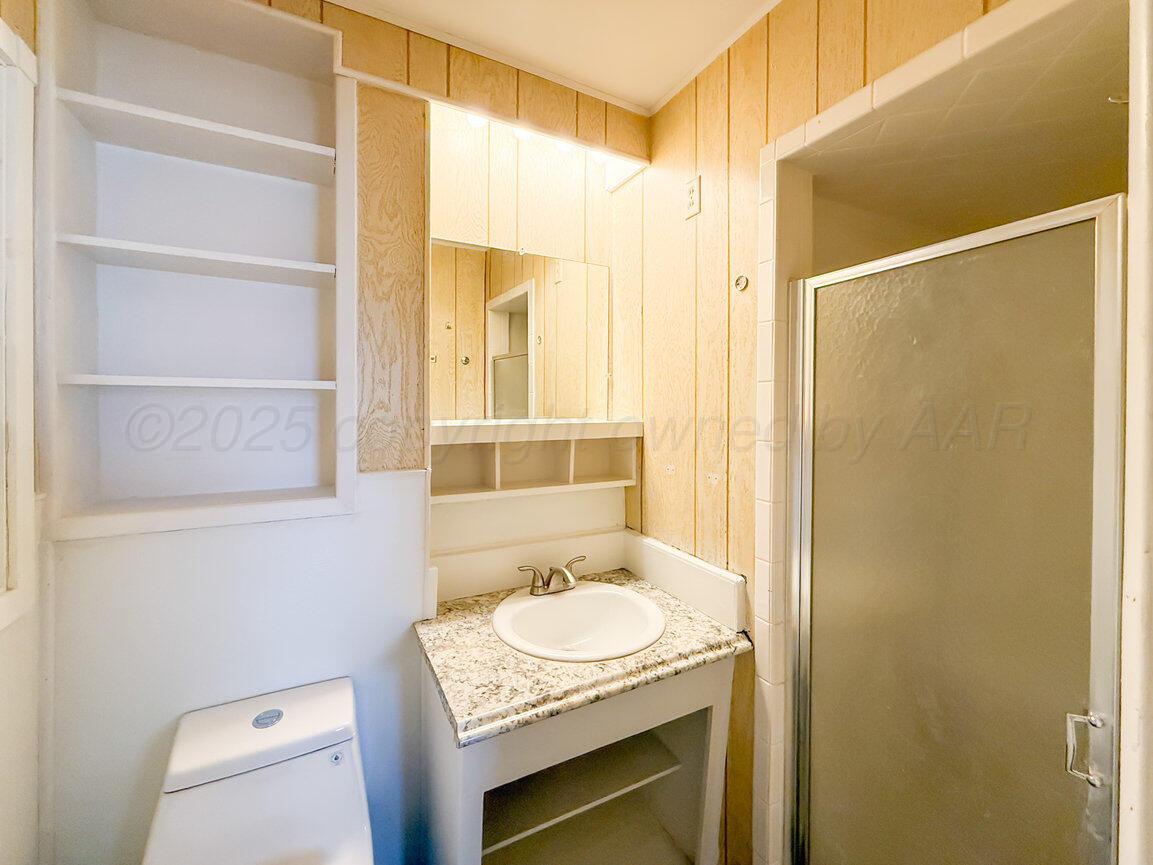1133 Elmore Street Borger, TX 79007 - Photo 28 of 43 a bathroom with a sink toilet and shower