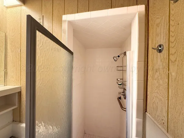 a bathroom with a shower and a sink