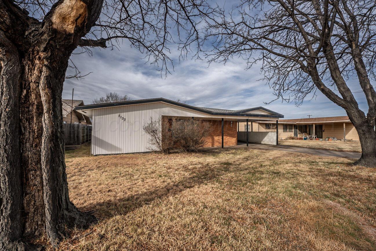 1133 Elmore Street Borger, TX 79007 - Photo 3 of 43 a front view of a house with a yard