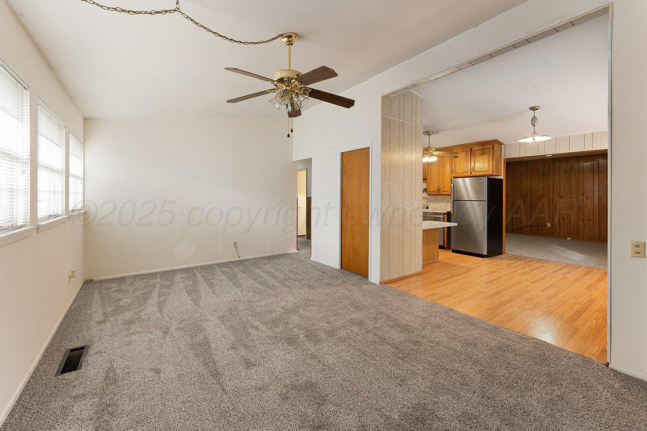 1133 Elmore Street Borger, TX 79007 - Photo 4 of 43 an empty room with closet and a chandelier fan