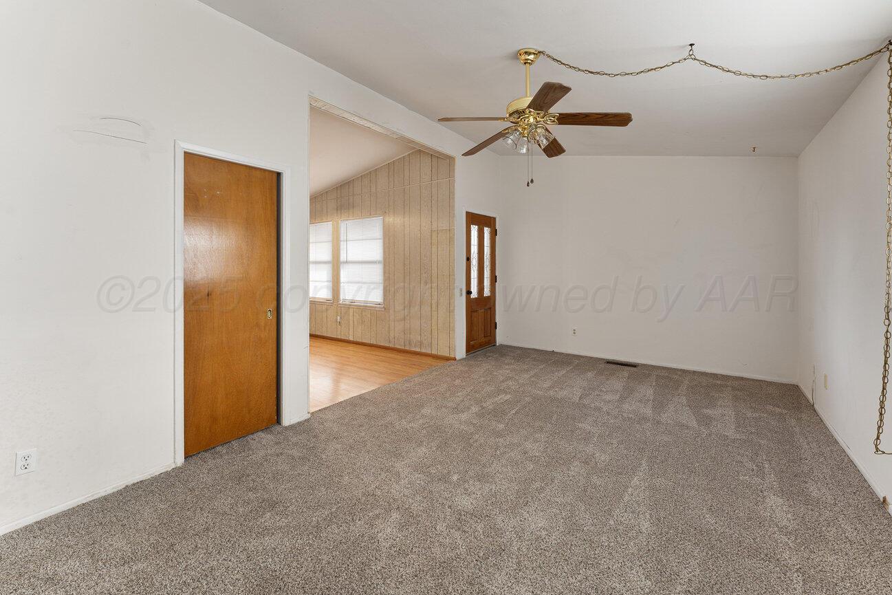1133 Elmore Street Borger, TX 79007 - Photo 7 of 43 a view of a hallway with closet and wooden floor