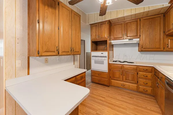 a kitchen with wooden cabinets and center island
