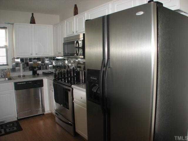 4833 Windbreak Lane Raleigh, NC 27616 - Photo 4 of 5 a kitchen with a refrigerator and a sink