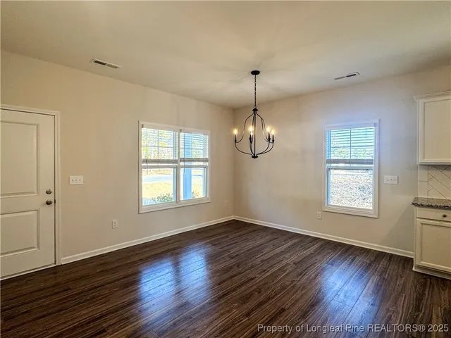 a kitchen with kitchen island granite countertop a sink refrigerator and cabinets