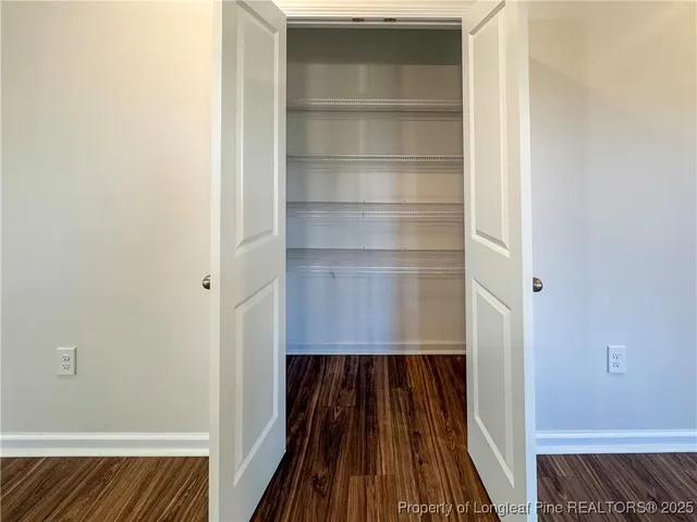a living room with a fireplace and a potted plant