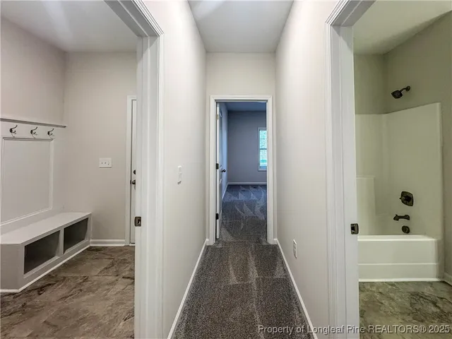 a bathroom with a tub and a window
