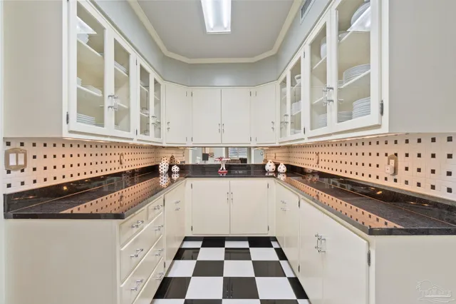 a kitchen with granite countertop a stove and cabinets