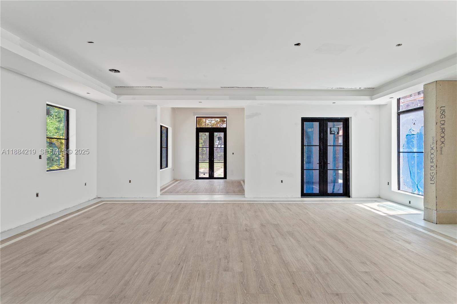 6460 Southwest 94th Street Pinecrest, FL 33156 - Photo 21 of 43 a view of an empty room with window and wooden floor