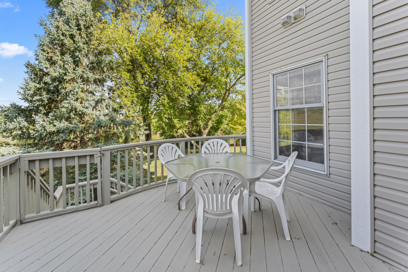 566 West Bridge View Court Palatine, IL 60067 - Photo 31 of 41 a view of a deck with table and chairs and wooden floor