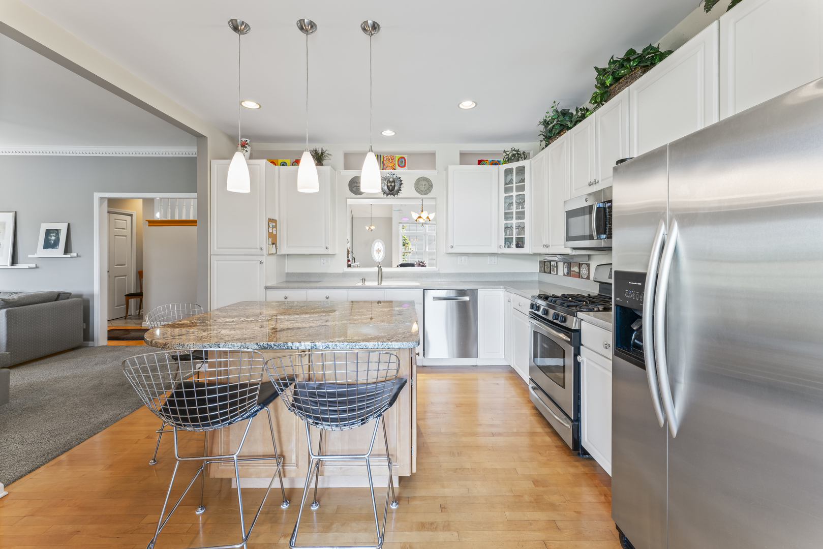 566 West Bridge View Court Palatine, IL 60067 - Photo 10 of 41 a kitchen with stainless steel appliances kitchen island granite countertop a refrigerator and a stove top oven