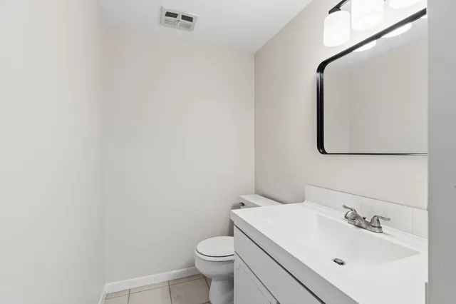 a bathroom with a sink vanity and mirror