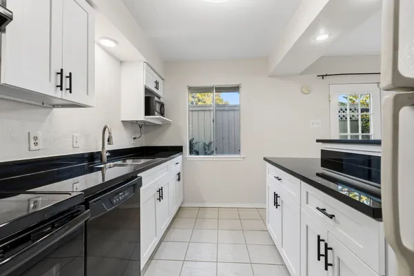 a kitchen with a sink stove and cabinets