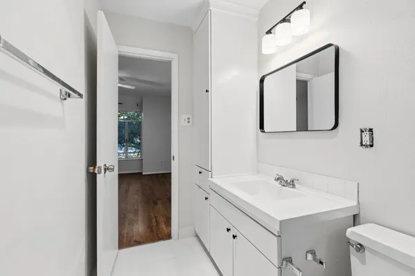 a view of a hallway with a ceiling fan