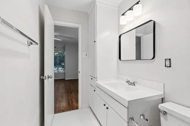 a view of a hallway with a ceiling fan