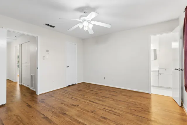 a bedroom with furniture and a wooden floor