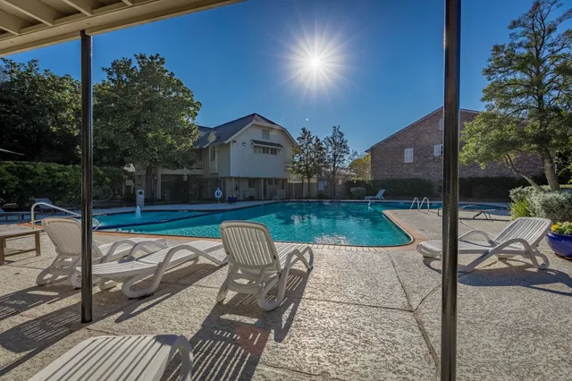 a swimming pool with outdoor seating and yard