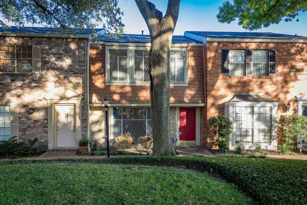 a view of a brick building next to a yard