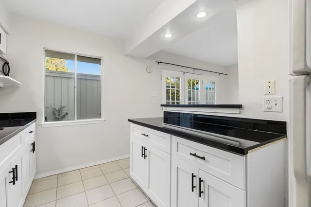 a kitchen with granite countertop a sink and a stove