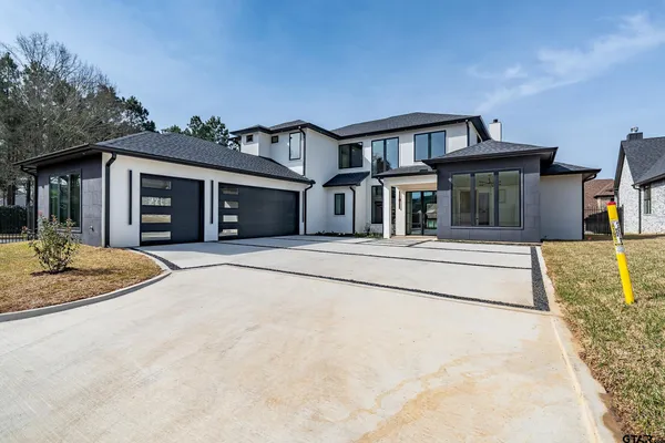 a spacious bathroom with a granite countertop sink mirror and a bathtub