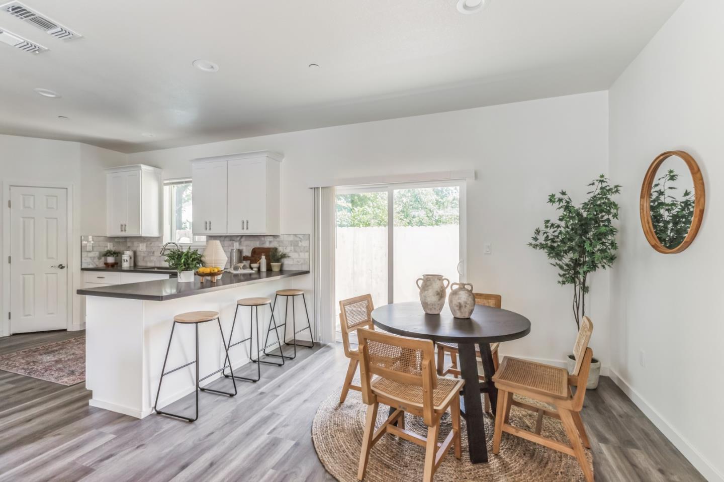 5443 Clint Place Sacramento, CA 95838 - Photo 1 of 29 a kitchen with a dining table chairs and white cabinets