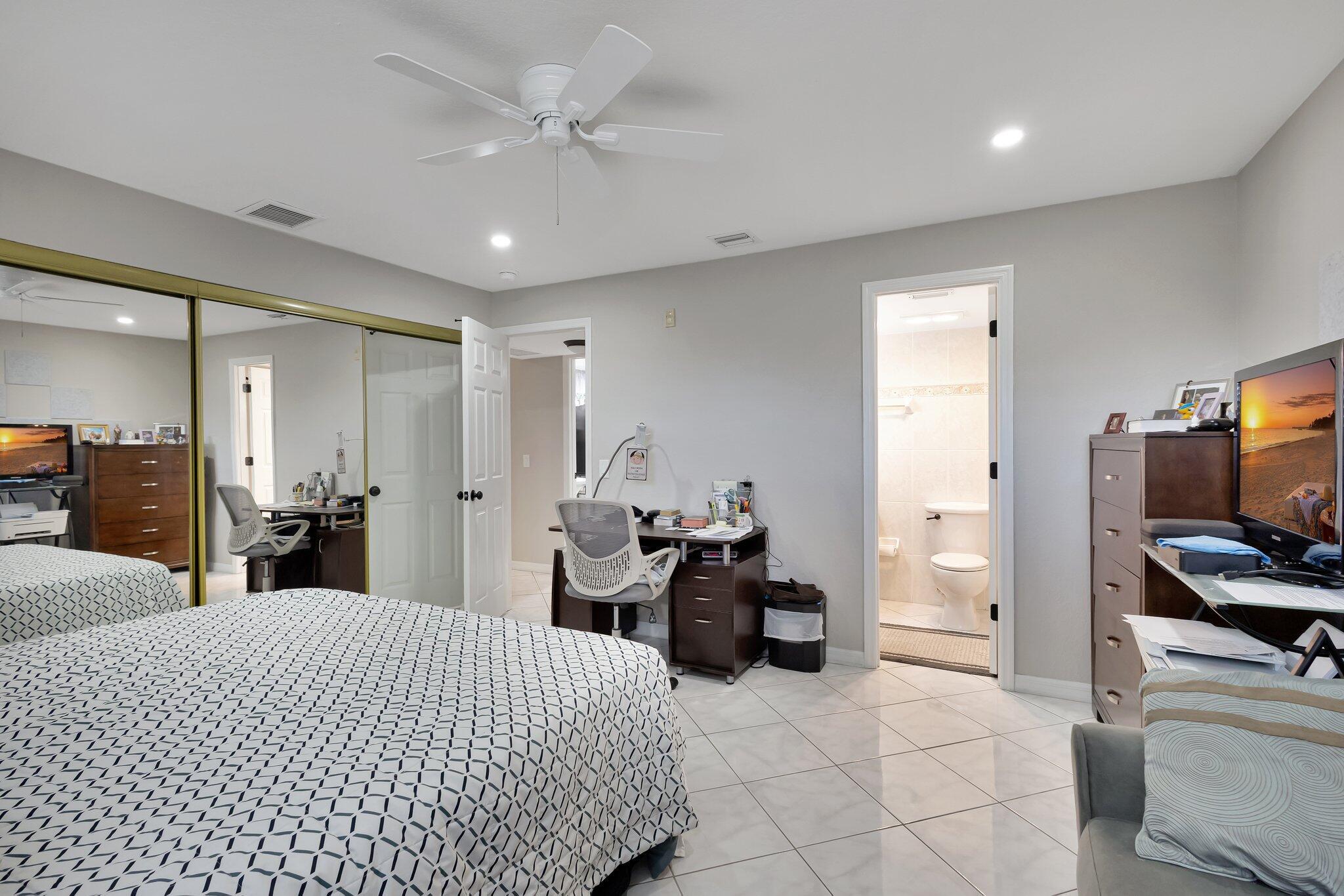 12012 Greenway Circle South, Unit 205 Royal Palm Beach, FL 33411 - Photo 27 of 36 a bed room with a bed and furniture