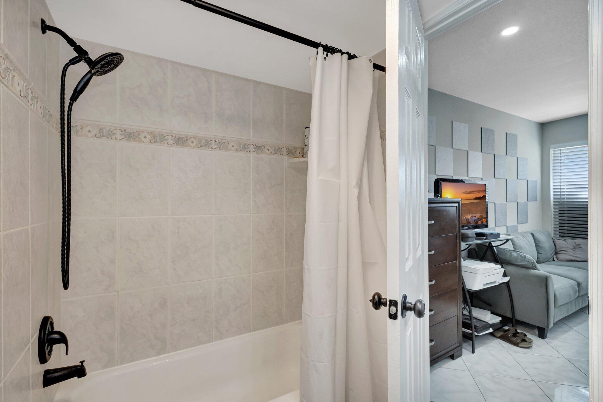 12012 Greenway Circle South, Unit 205 Royal Palm Beach, FL 33411 - Photo 29 of 36 a bathroom with a sink toilet and shower