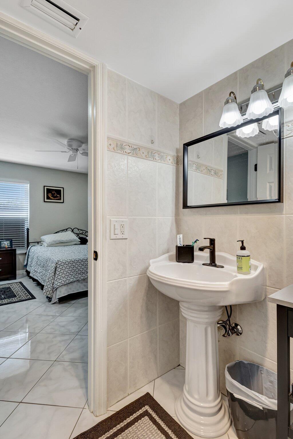 12012 Greenway Circle South, Unit 205 Royal Palm Beach, FL 33411 - Photo 30 of 36 a bathroom with a sink and a mirror