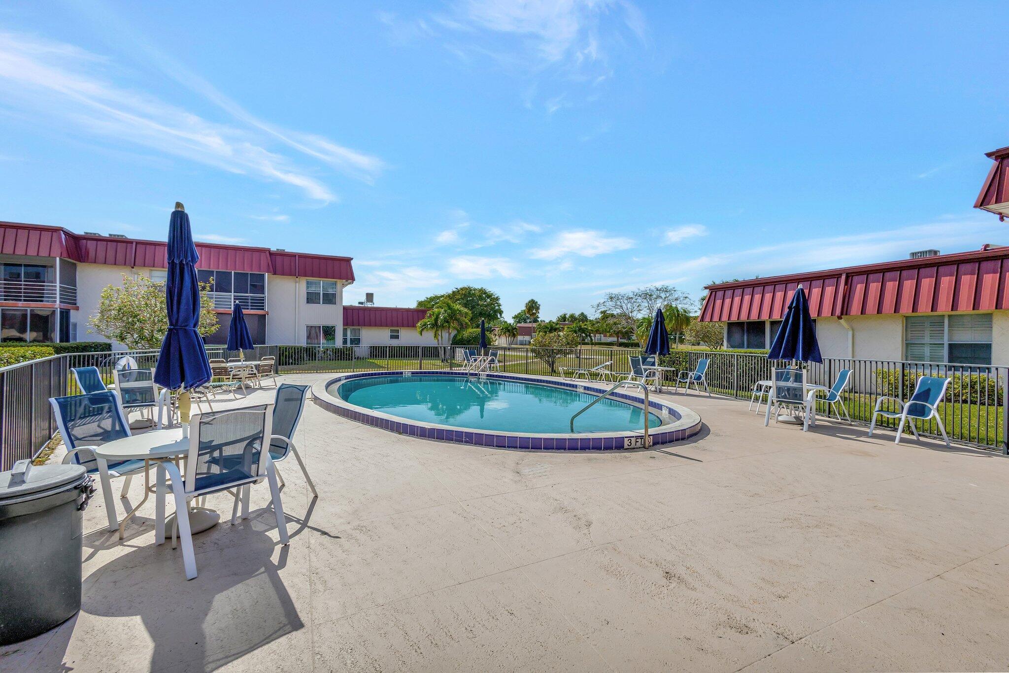12012 Greenway Circle South, Unit 205 Royal Palm Beach, FL 33411 - Photo 35 of 36 a view of a chairs and table in the patio