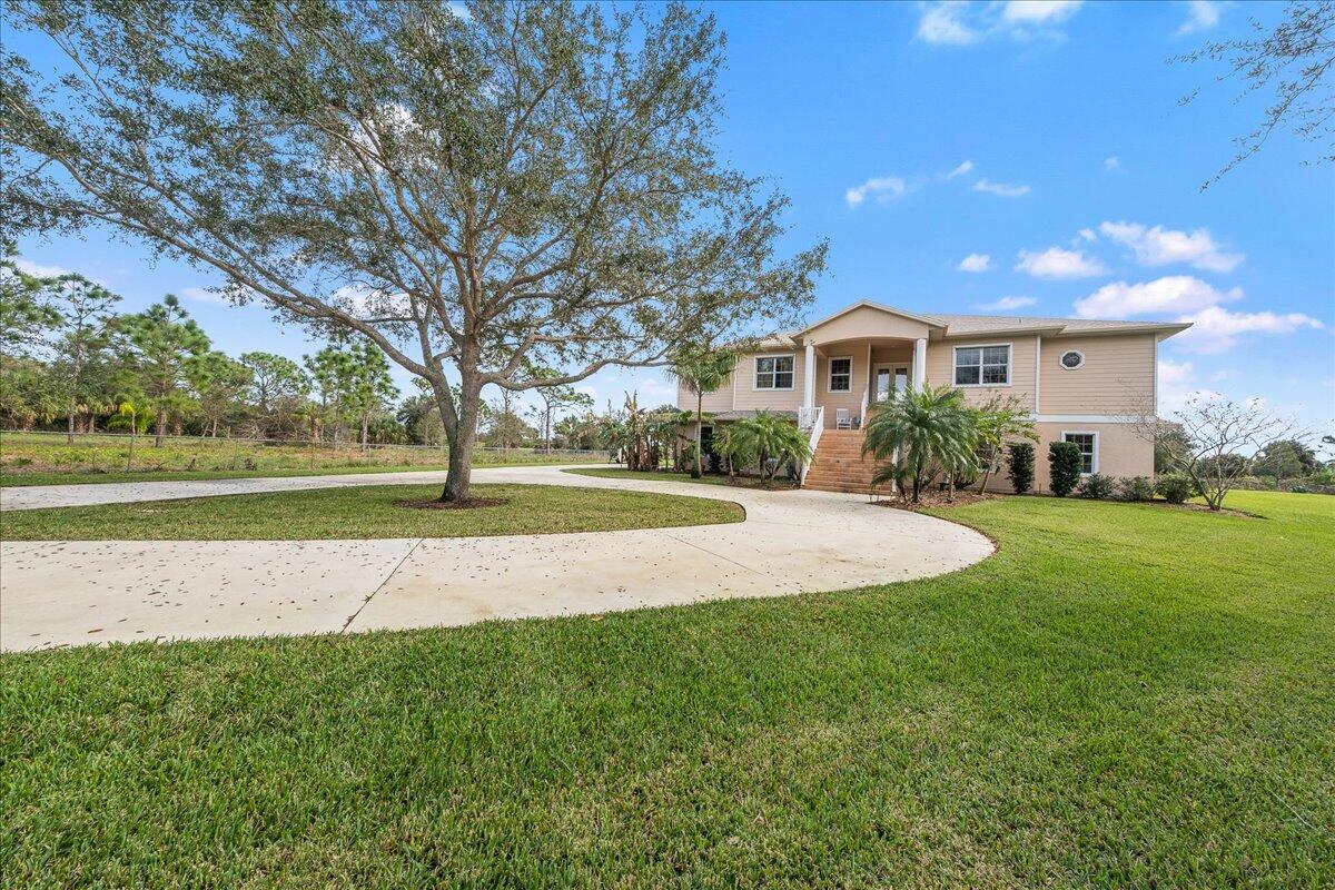 2940 Pomello Road Malabar, FL 32950 - Photo 1 of 42 a view of a house with a big yard and palm trees