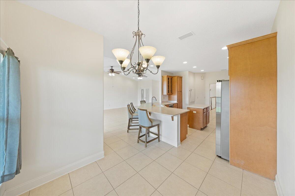 2940 Pomello Road Malabar, FL 32950 - Photo 15 of 42 a view of a dining room with furniture and a chandelier fan