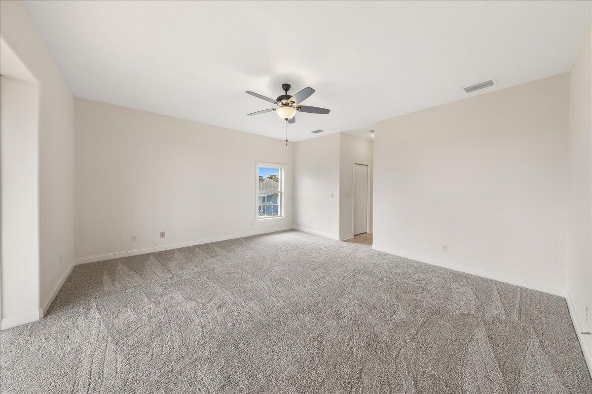 2940 Pomello Road Malabar, FL 32950 - Photo 17 of 42 a view of a big room with chandelier fan and windows