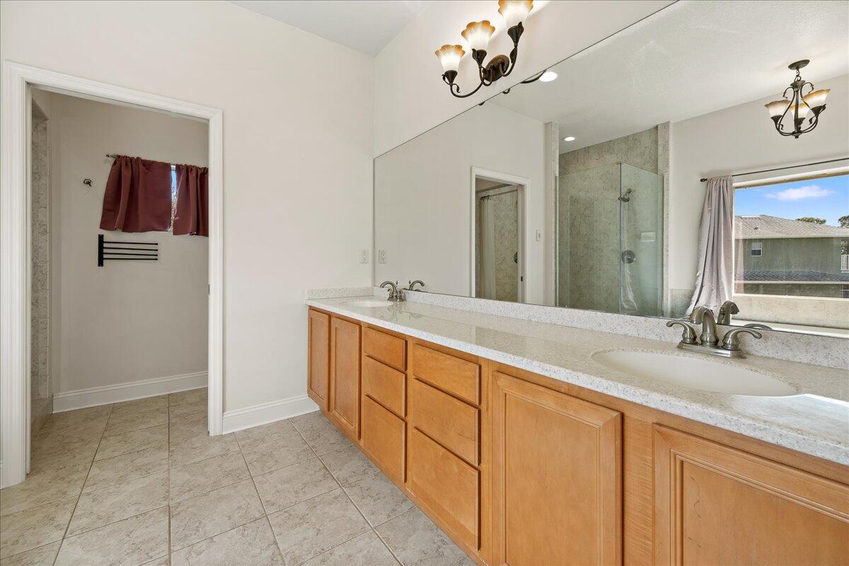 2940 Pomello Road Malabar, FL 32950 - Photo 18 of 42 a spacious bathroom with a double vanity sink a mirror and shower