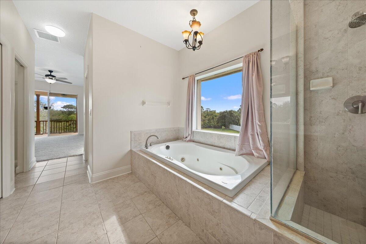 2940 Pomello Road Malabar, FL 32950 - Photo 19 of 42 a bathroom with a tub a sink and a shower