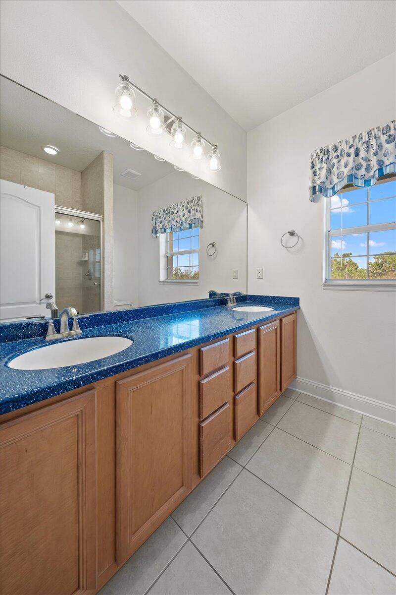 2940 Pomello Road Malabar, FL 32950 - Photo 21 of 42 a spacious bathroom with a granite countertop sink and a mirror