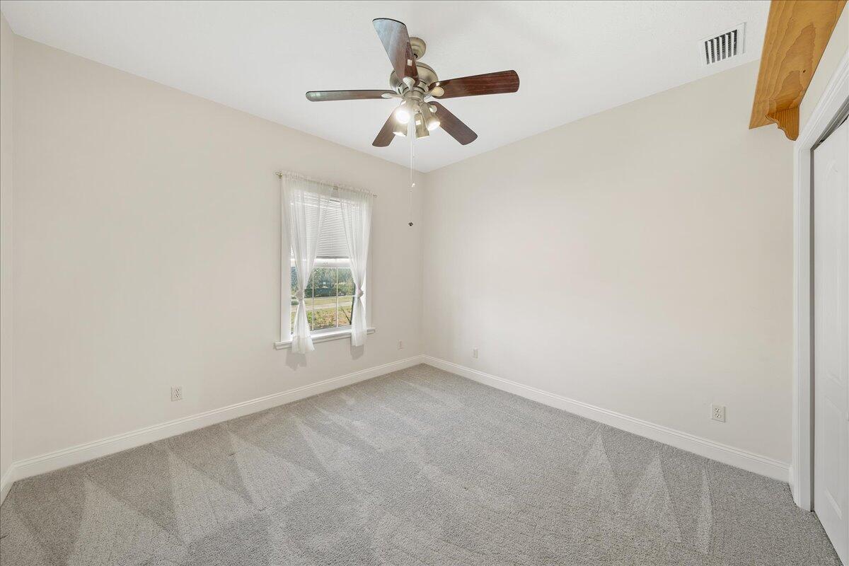 2940 Pomello Road Malabar, FL 32950 - Photo 28 of 42 an empty room with a window and a fan