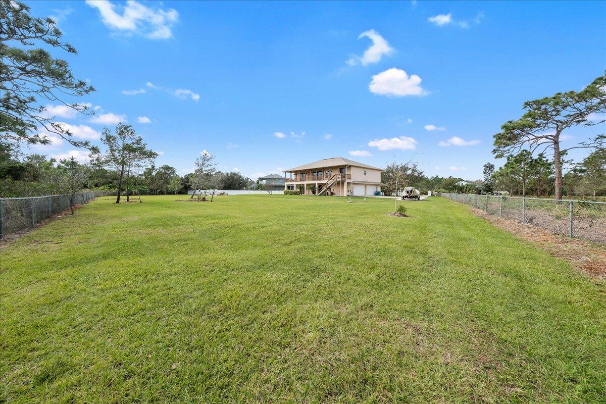 2940 Pomello Road Malabar, FL 32950 - Photo 35 of 42 a view of a big yard with an outdoor space and seating