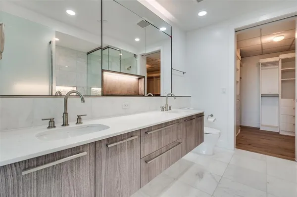a bathroom with a double vanity sink and a mirror