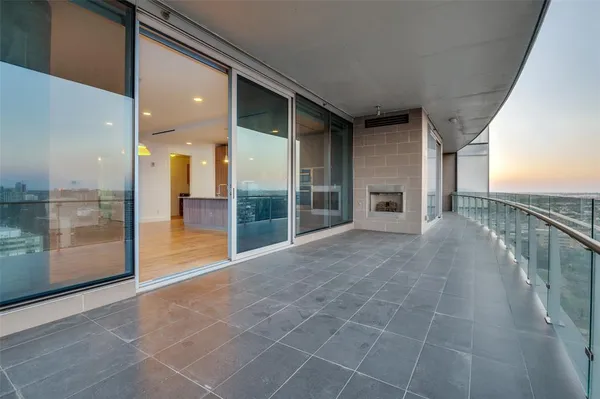 a view of a hallway with wooden floor and a living room