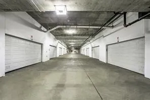a living room with couches chairs and a potted plant