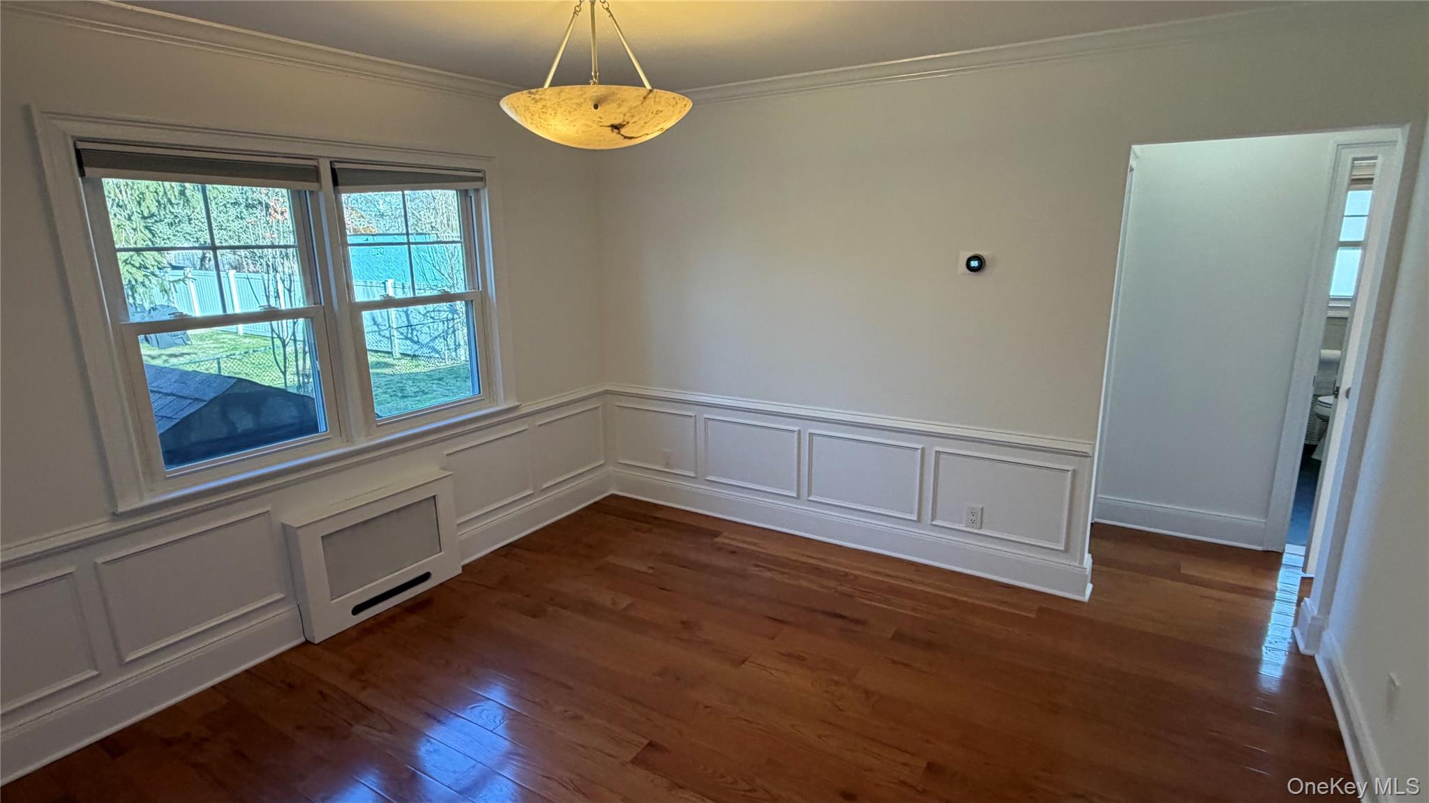 2 Wyman Street, Unit 1 Rye Brook, NY 10573 - Photo 6 of 13 an empty room with wooden floor and windows