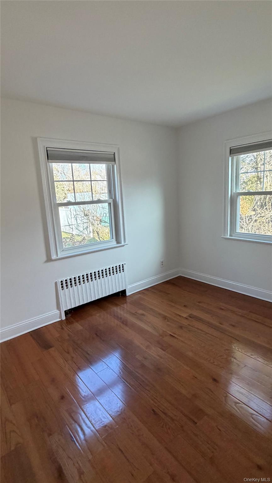 2 Wyman Street, Unit 1 Rye Brook, NY 10573 - Photo 7 of 13 an empty room with wooden floor and windows