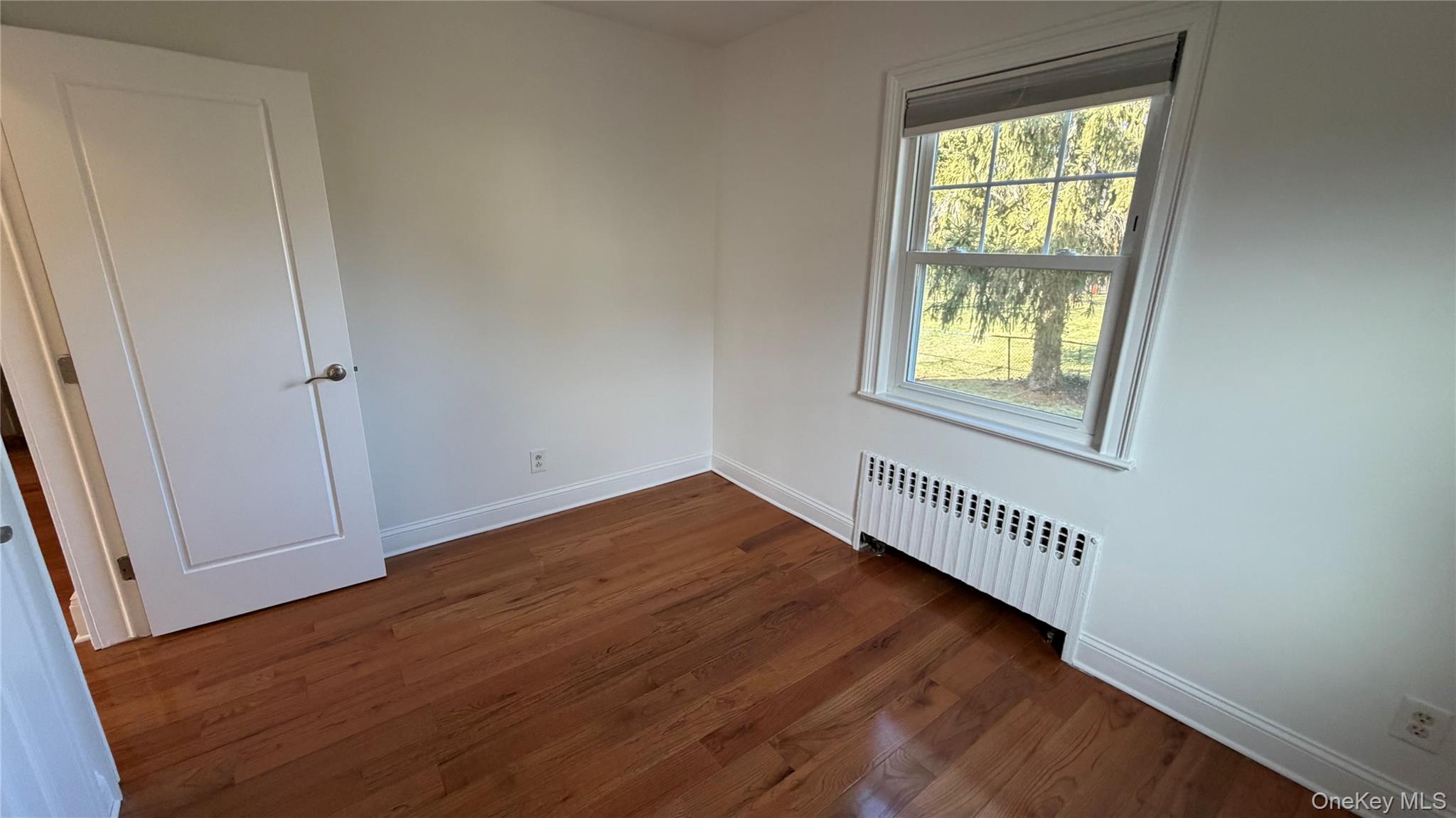 2 Wyman Street, Unit 1 Rye Brook, NY 10573 - Photo 8 of 13 an empty room with wooden floor and windows