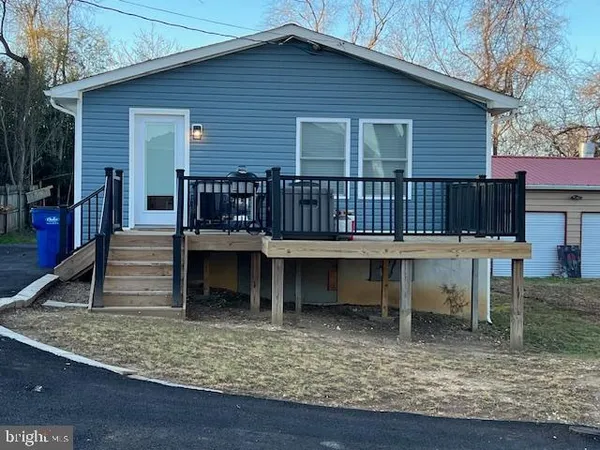 a view of a house with a yard and sitting area