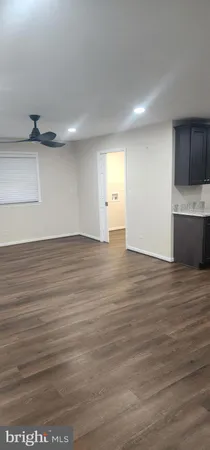a view of a room with wooden floor